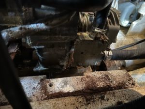 diesel motor suspended, showing an empty spot where the motor mount will be installed